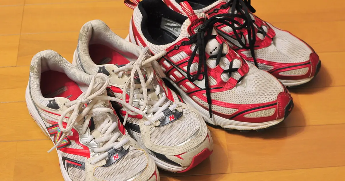 A pair of running shoes on a wooden floor