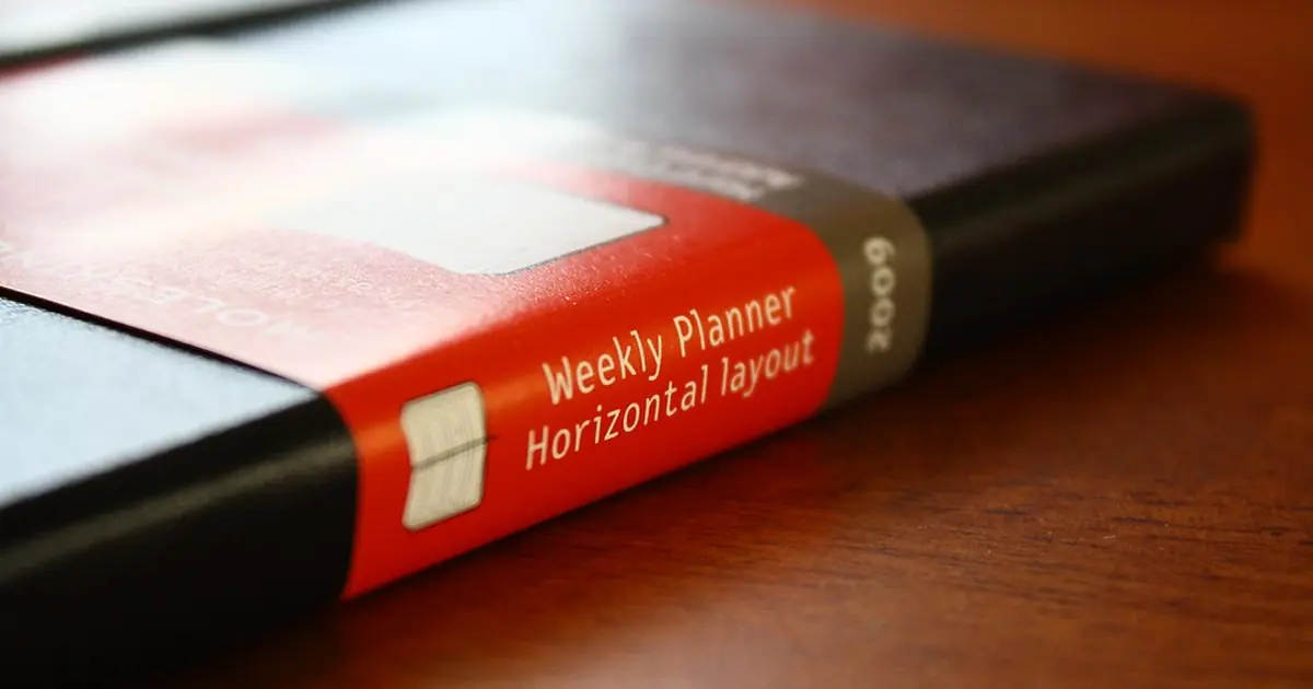 A red weekly planner notebook